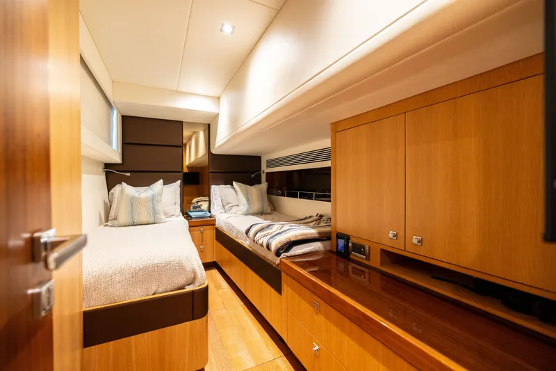 Slide: The Image of Luxurious twin cabin interior on 2019 Horizon PC65 yacht, featuring elegant wood finishes. - 46