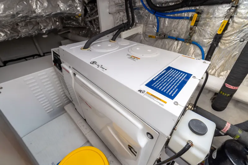 Slide: The Image of Engine room of a 2019 Horizon PC65 yacht with mechanical equipment and piping. - 53