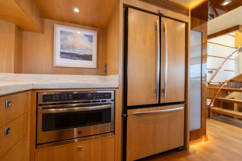 Slide: The Image of Modern kitchen in 2019 Horizon PC65 yacht with wood cabinetry and stainless steel appliances. - 28