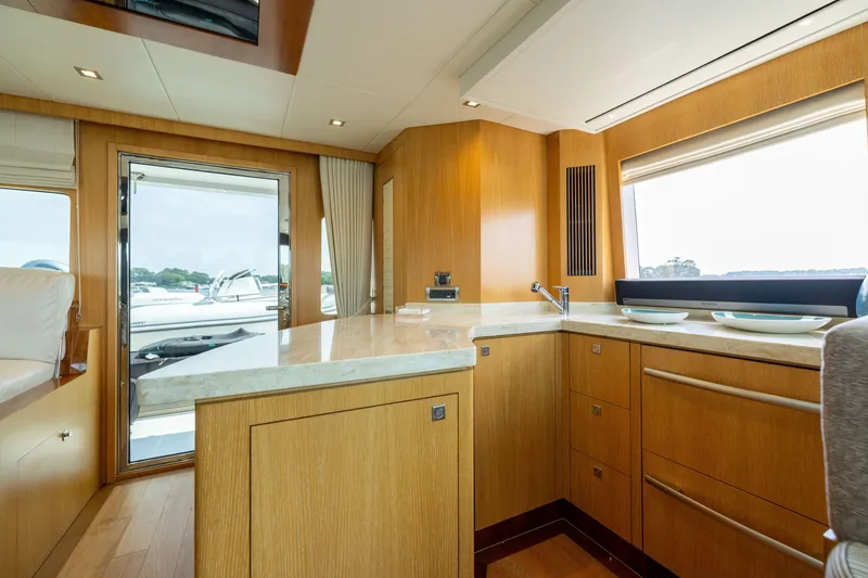 Slide: The Image of Luxurious interior of 2019 Horizon PC65 yacht with modern kitchen and scenic window view. - 17