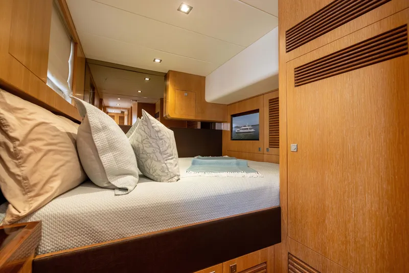 Slide: The Image of Luxurious cabin interior of 2019 Horizon PC65 yacht with cozy bedding and wooden finishes. - 43