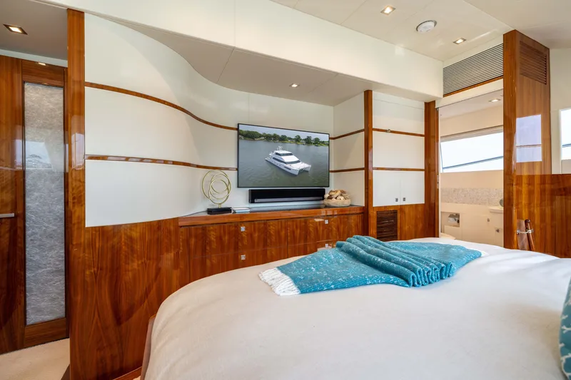 Slide: The Image of Luxurious 2019 Horizon PC65 yacht bedroom with elegant wood paneling and modern decor. - 37