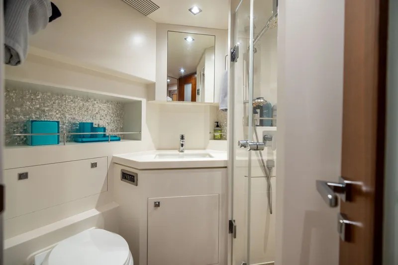 Slide: The Image of Modern yacht bathroom with shower, sink, and storage in 2019 Horizon PC65 model. - 44