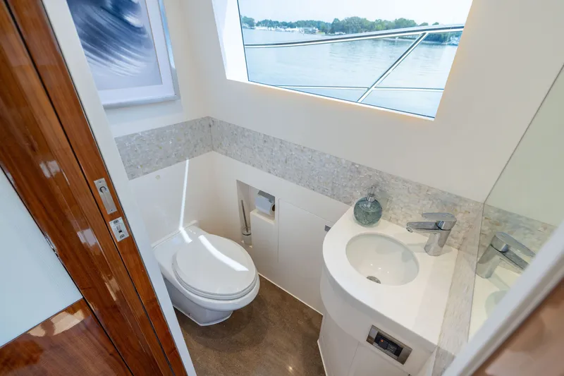 Slide: The Image of Luxurious yacht bathroom with modern fixtures, large window, and elegant design on Horizon PC65, 2019. - 49