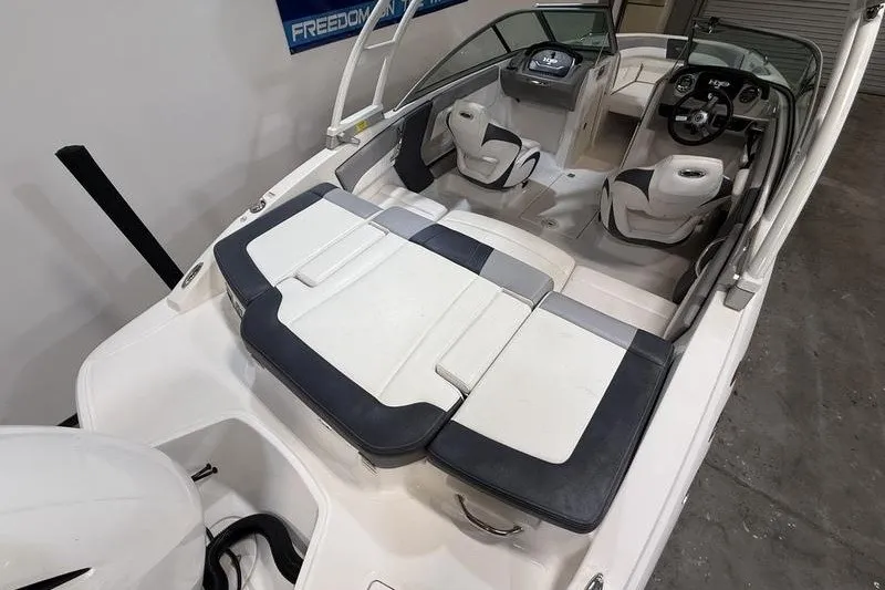 Slide: The Image of 2019 Chaparral 23 H2O Sport boat interior with seating and steering console. - 5