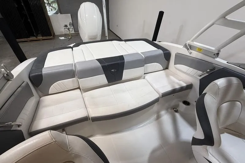 Slide: The Image of 2019 Chaparral 23 H2O Sport boat interior with white and gray seating. - 9