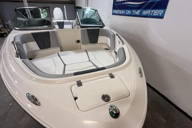 Slide: The Image of 2019 Chaparral 23 H2O Sport boat interior with seating and storage compartments. - 18