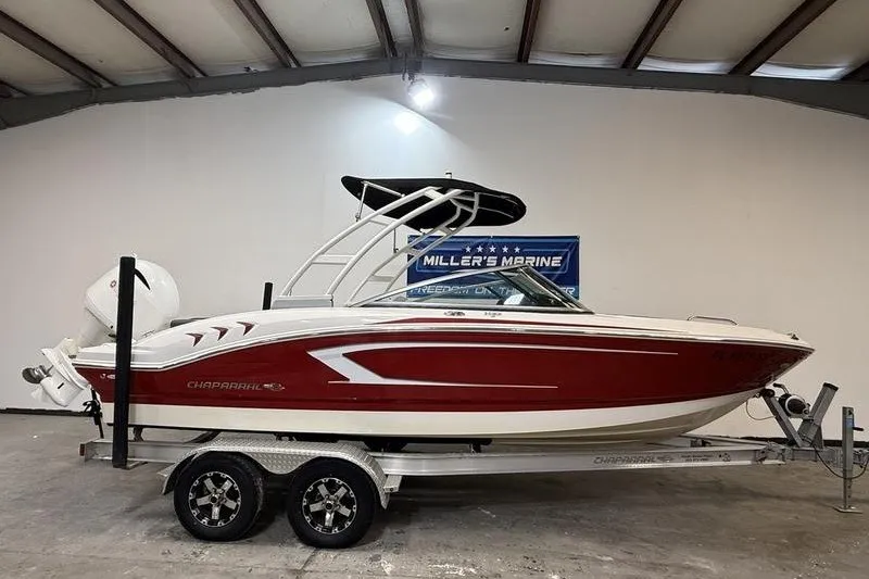 The Image of 2019 Chaparral 23 H2O Sport boat on trailer in indoor showroom. - 0