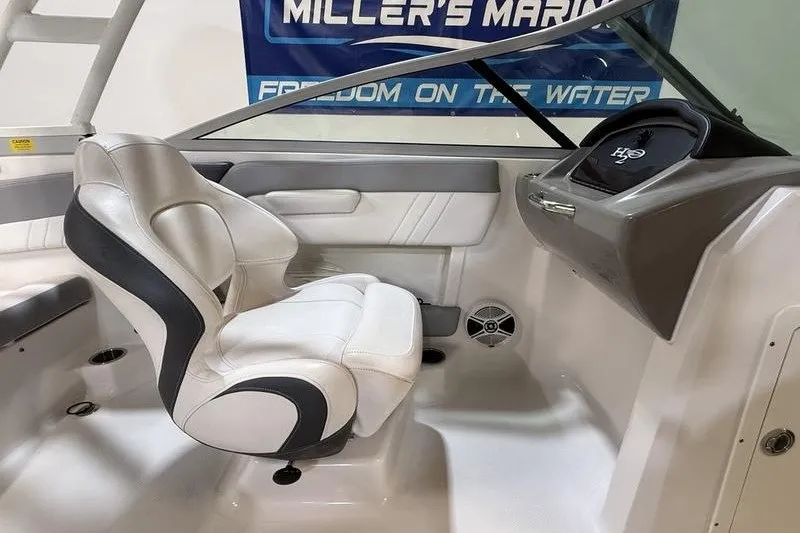 Slide: The Image of Interior of 2019 Chaparral 23 H2O Sport boat with white seating and dashboard. - 14
