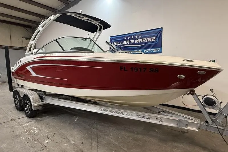 Slide: The Image of 2019 Chaparral 23 H2O Sport boat on trailer in showroom setting. - 1
