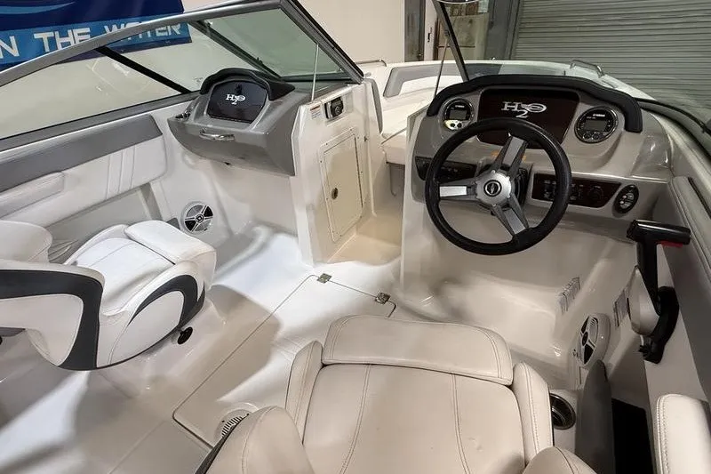 Slide: The Image of Interior view of 2019 Chaparral 23 H2O Sport boat cockpit with steering wheel and seating. - 12