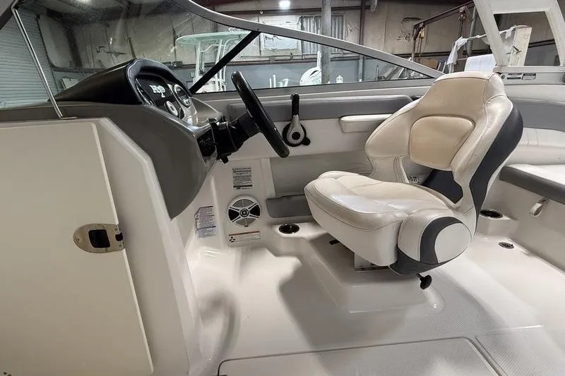 Slide: The Image of 2019 Chaparral 23 H2O Sport boat interior with steering wheel and captain's seat. - 15