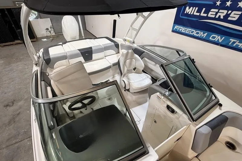 Slide: The Image of 2019 Chaparral 23 H2O Sport boat interior with seating and steering wheel. - 16