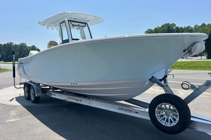 The Image of 2026 Sportsman Open 262 Center Console boat on trailer, parked outdoors. - 1