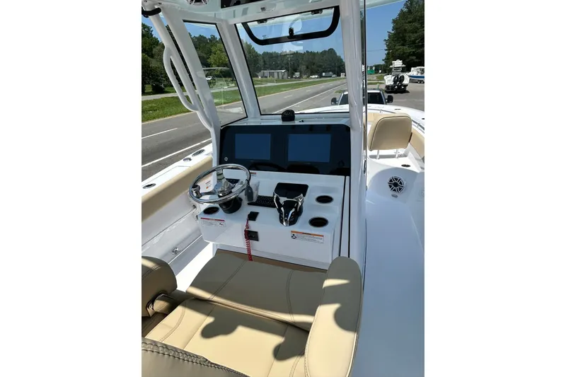 Slide: The Image of 2026 Sportsman Open 262 Center Console boat interior with steering wheel and navigation screens. - 3