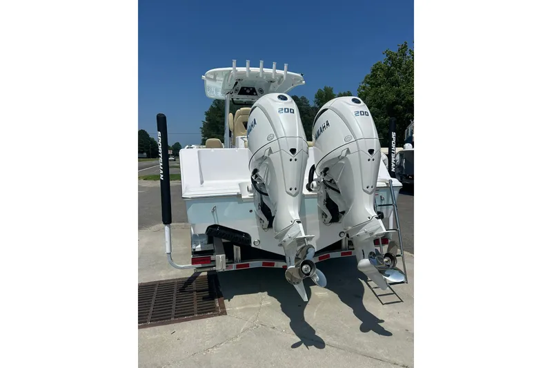 Slide: The Image of 2026 Sportsman Open 262 Center Console with twin Yamaha 200 engines, parked outdoors. - 2