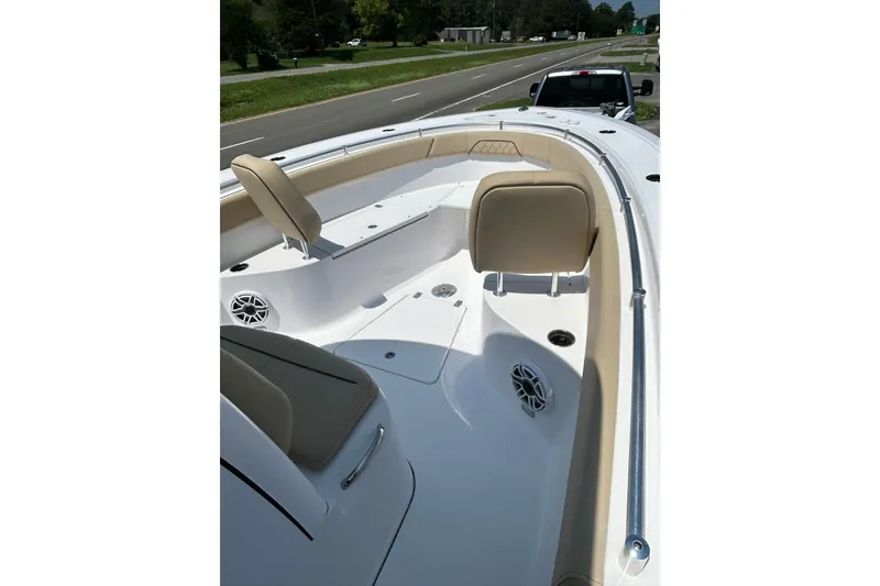Slide: The Image of 2026 Sportsman Open 262 Center Console boat interior with beige seating and speakers. - 4