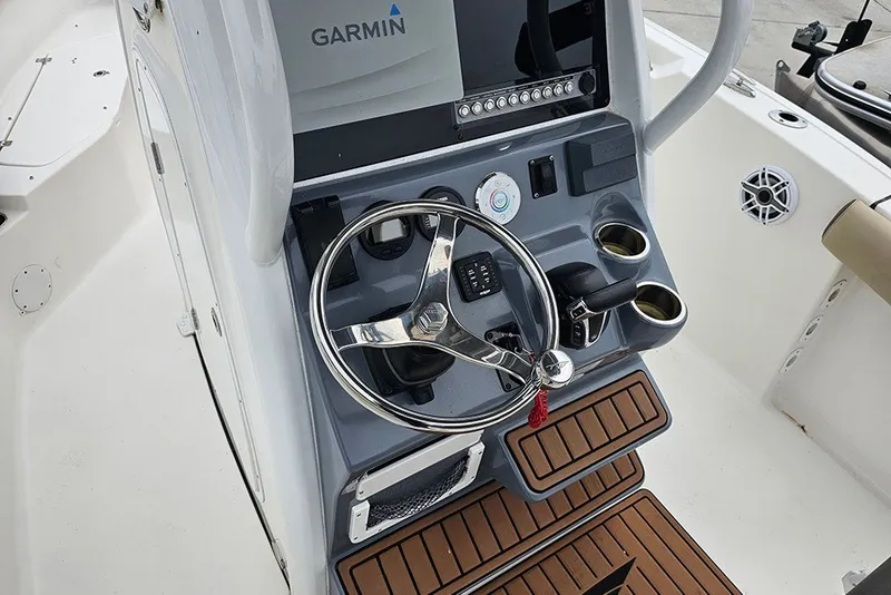 Slide: The Image of 2021 Tidewater 232 CC Adventure boat console with Garmin display and steering wheel. - 16