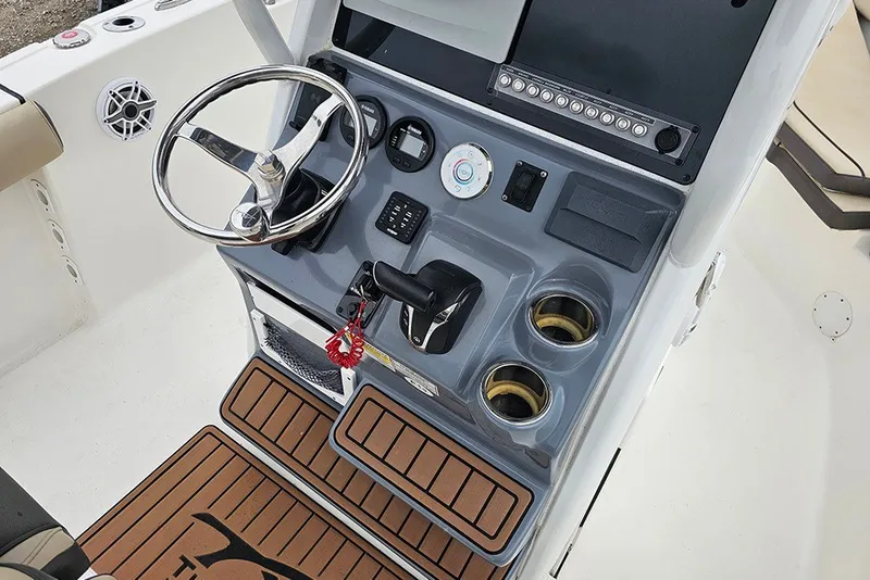 Slide: The Image of 2021 Tidewater 232 CC Adventure boat console with steering wheel and controls. - 27