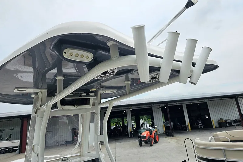 Slide: The Image of Tidewater 232 CC Adventure 2021 boat with rod holders and T-top in a marina setting. - 18