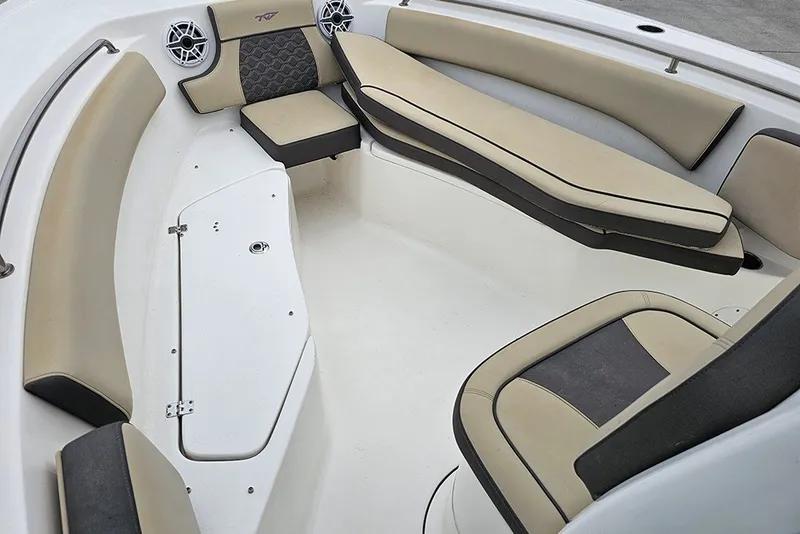 Slide: The Image of 2021 Tidewater 232 CC Adventure boat interior with beige and black cushioned seating. - 21