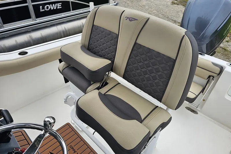Slide: The Image of 2021 Tidewater 232 CC Adventure boat seats with beige and black upholstery. - 15