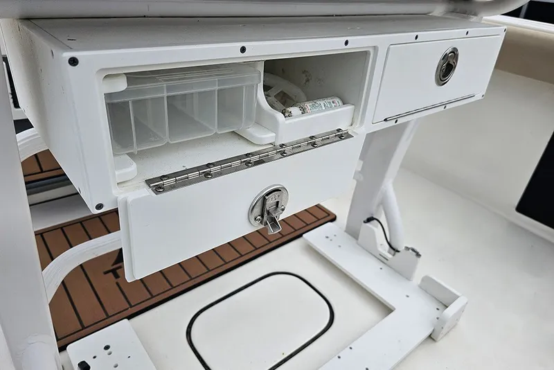 Slide: The Image of 2021 Tidewater 232 CC Adventure boat storage compartment with tackle box and lockable drawer. - 14