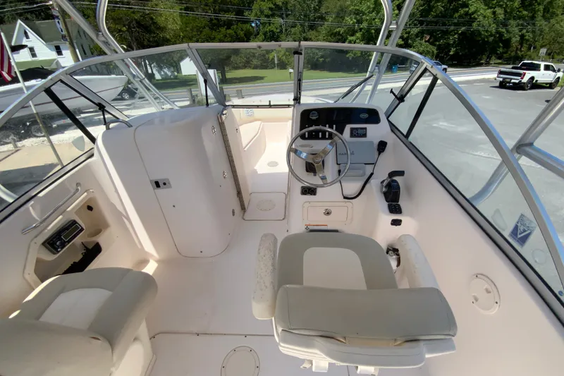 Slide: The Image of 2011 Grady-White Freedom 255 boat interior with steering wheel and seating. - 11