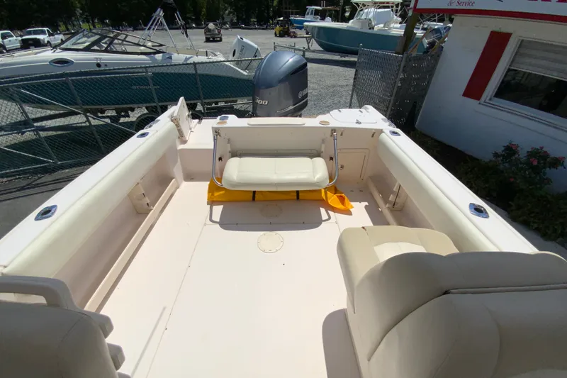 Slide: The Image of 2011 Grady-White Freedom 255 boat interior with seating and Yamaha engine. - 14