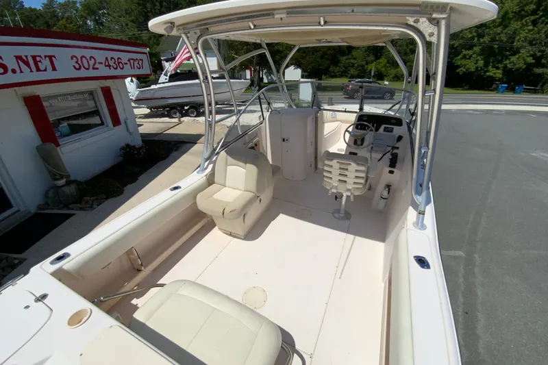 Slide: The Image of 2011 Grady-White Freedom 255 boat interior with seating and steering console. - 10
