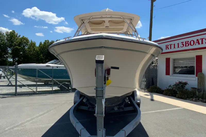 Slide: The Image of 2011 Grady-White Freedom 255 boat on trailer at dealership, sunny day. - 4