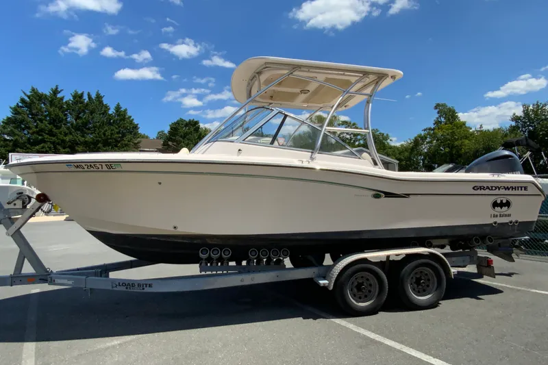 Slide: The Image of 2011 Grady-White Freedom 255 boat on trailer under clear blue sky. - 6