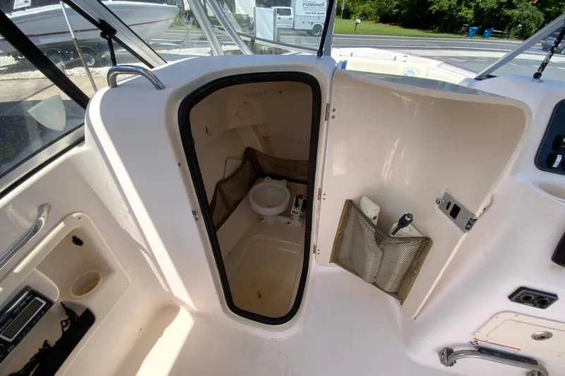 Slide: The Image of Interior view of a 2011 Grady-White Freedom 255 boat's compact bathroom area. - 22