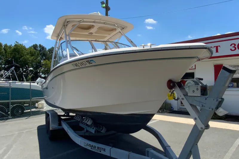 Slide: The Image of 2011 Grady-White Freedom 255 boat on trailer under clear blue sky. - 3