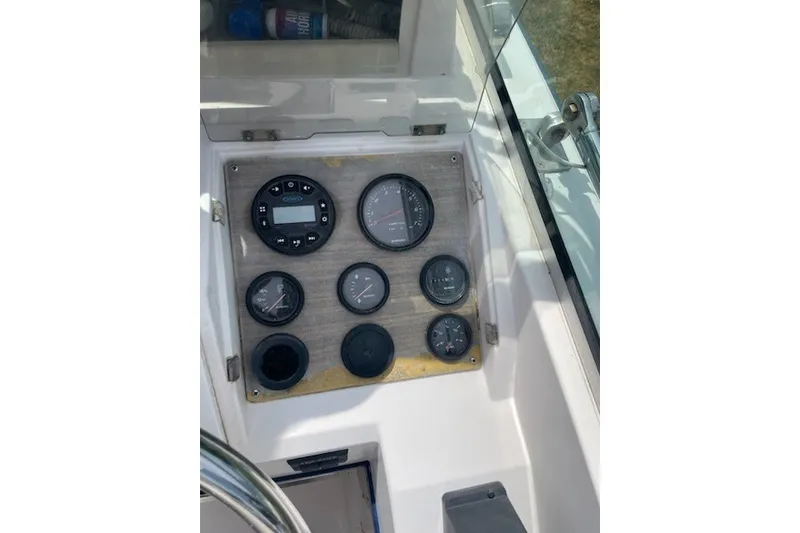 Slide: The Image of Dashboard of a 1990 Grady-White Tournament 192 boat with various gauges and controls. - 8