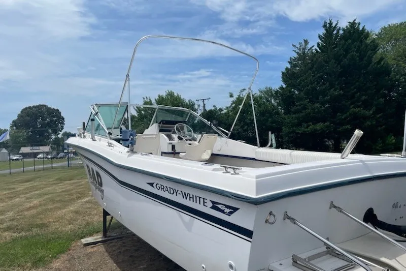 Slide: The Image of 1990 Grady-White Tournament 192 boat on display outdoors, clear sky background. - 5