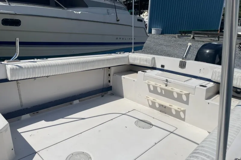 Slide: The Image of 1990 Grady-White Tournament 192 boat interior with seating and storage compartments. - 12