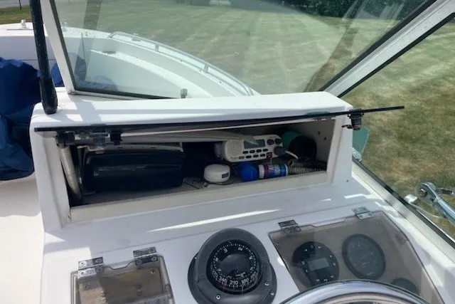 Slide: The Image of Dashboard of a 1990 Grady-White Tournament 192 boat with storage compartment open. - 10