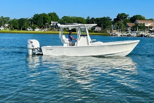 The Image of 2027 Pair Customs 24 Center Console DV boat cruising on a sunny day. - 0