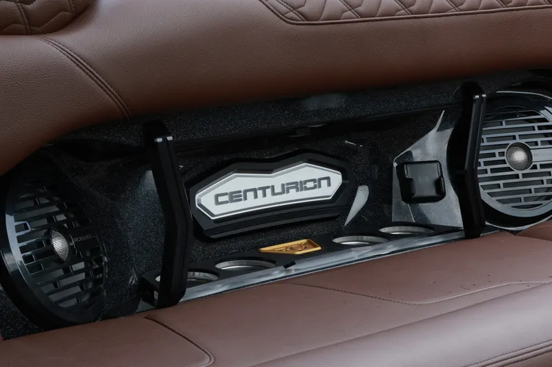 Slide: The Image of 2026 Centurion Ri265 interior detail with premium audio system and brown leather seating. - 13