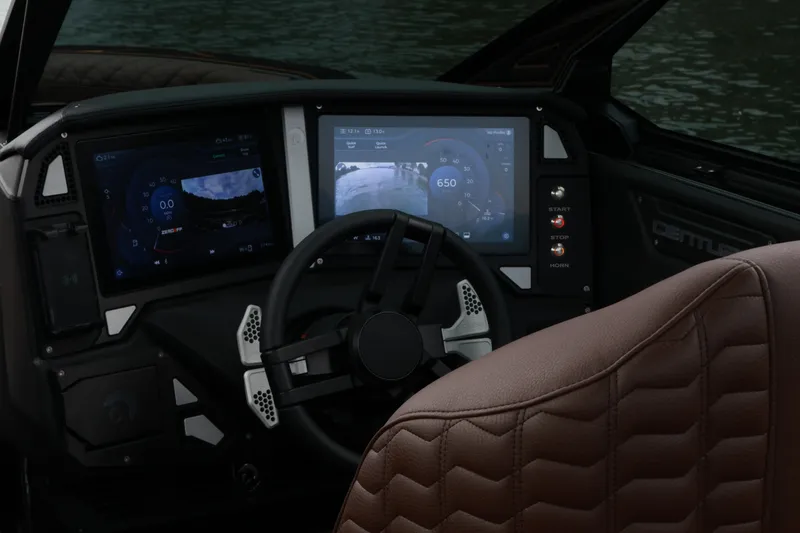 Slide: The Image of 2026 Centurion Ri265 dashboard with digital displays and steering wheel, overlooking water. - 10