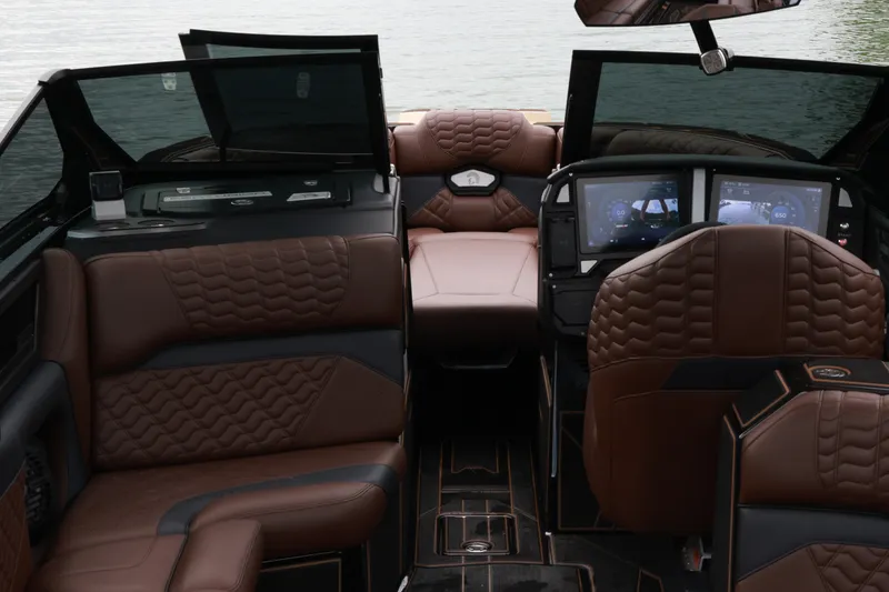 Slide: The Image of Luxurious interior of 2026 Centurion Ri265 boat with brown leather seating and advanced dashboard. - 9