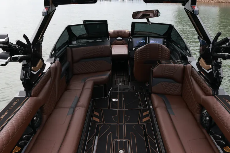 Slide: The Image of Luxurious interior of 2026 Centurion Ri265 boat with brown leather seating and modern dashboard. - 8