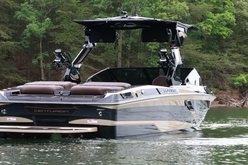 Slide: The Image of 2026 Centurion Ri265 boat on a serene lake, surrounded by lush greenery. - 4
