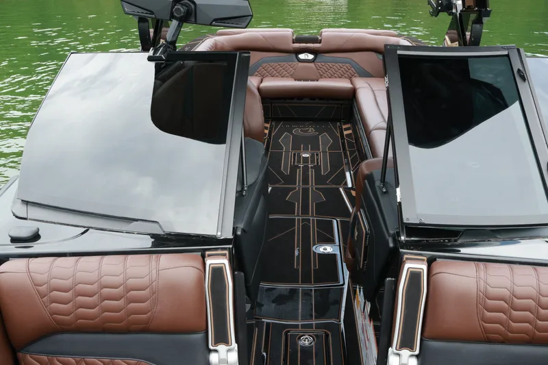 Slide: The Image of 2026 Centurion Ri265 boat interior with luxurious brown leather seating and sleek design. - 12