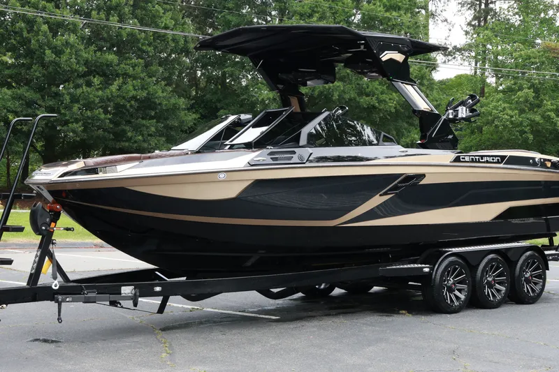 Slide: The Image of 2026 Centurion Ri265 boat on trailer, sleek design, parked outdoors. - 7