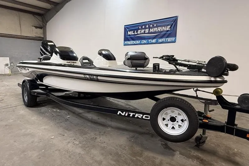 Slide: The Image of 2009 Nitro Z-7 boat on trailer in showroom, Miller's Marine banner in background. - 1