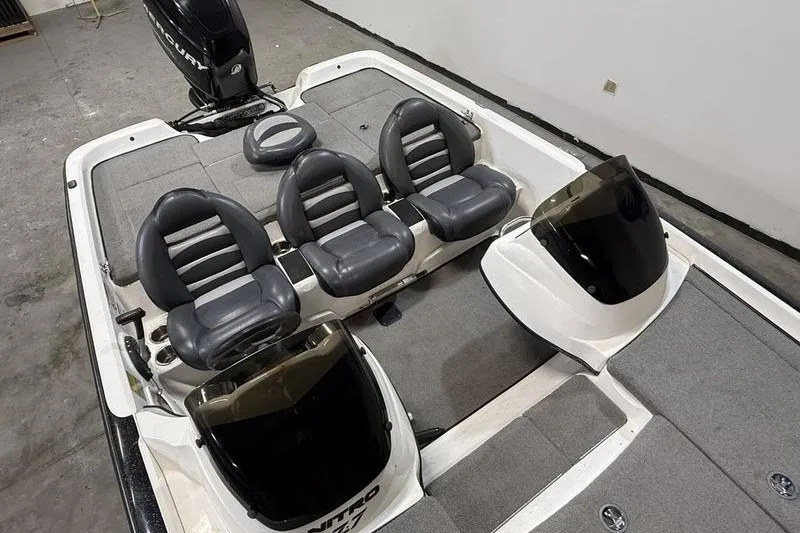 Slide: The Image of 2009 Nitro Z-7 boat interior with three seats and dual consoles. - 7