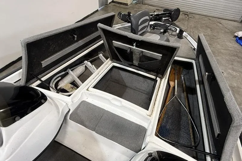 Slide: The Image of 2009 Nitro Z-7 boat interior with open storage compartments and fishing gear. - 8