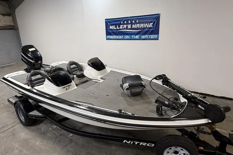 Slide: The Image of 2009 Nitro Z-7 boat in showroom, featuring Mercury engine and Miller's Marine banner. - 2